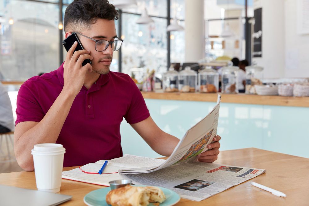 a busy branch manager checking a review alert between tasks